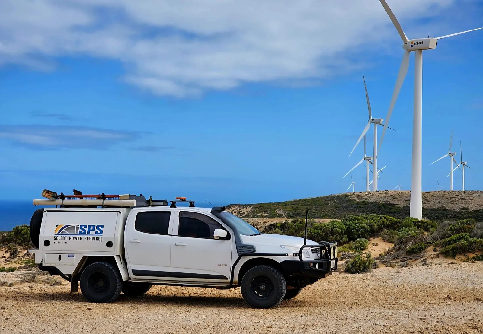 Select Power Services branded vehicle at a wind farm site