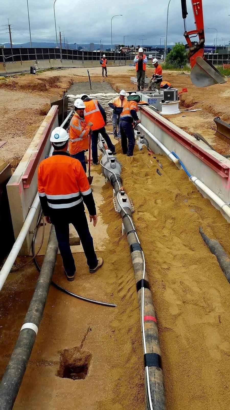 Cable jointing crew laying cable on site